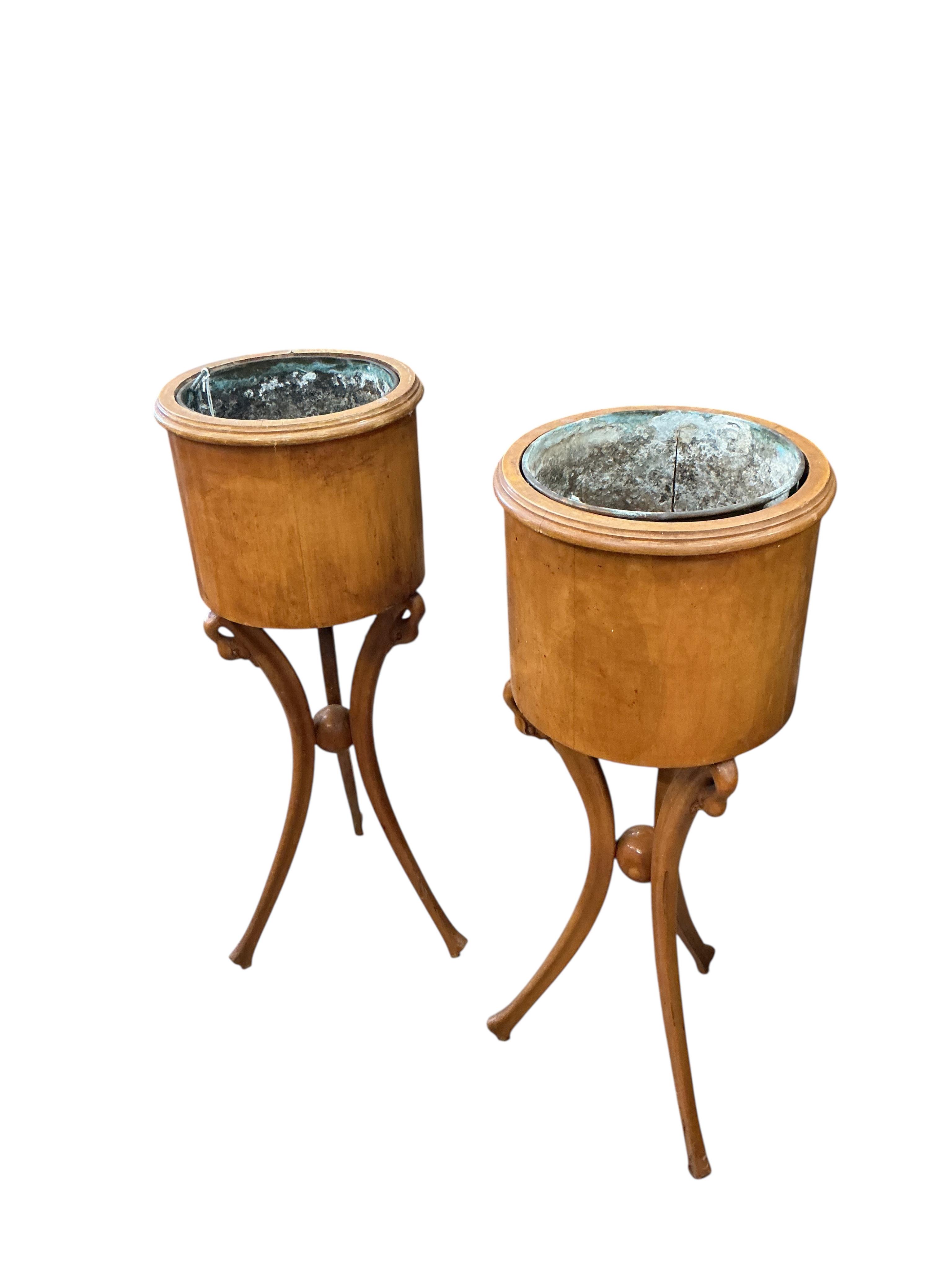 A pair of Empire style circular mahogany jardinieres with swan neck tripod bases, height 83cm